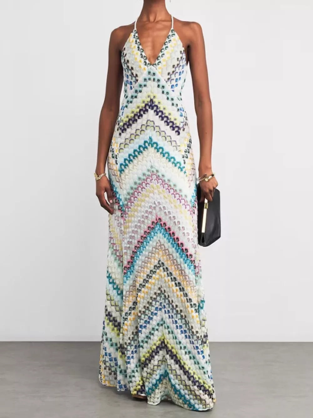 Chevron knit maxi dress with crisscross halter neckline and colorful zigzag pattern.