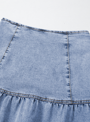 Medium wash denim mini skirt with asymmetrical ruffle hem detail