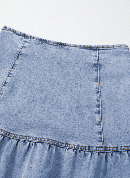 Medium wash denim mini skirt with asymmetrical ruffle hem detail