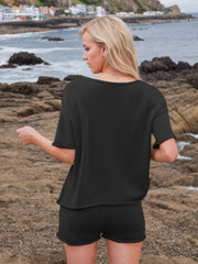 Black textured knit co-ord set with relaxed fit top and shorts.