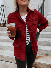 Utility jacket in Rust with multiple pockets and a zip-snap front closure.