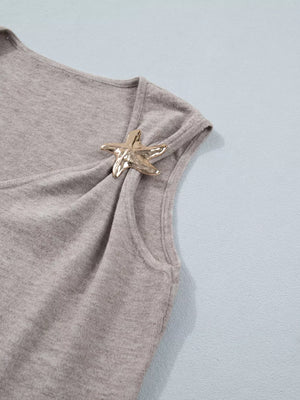 Grey V-neck knit vest with a gold starfish embellishment on the shoulder.