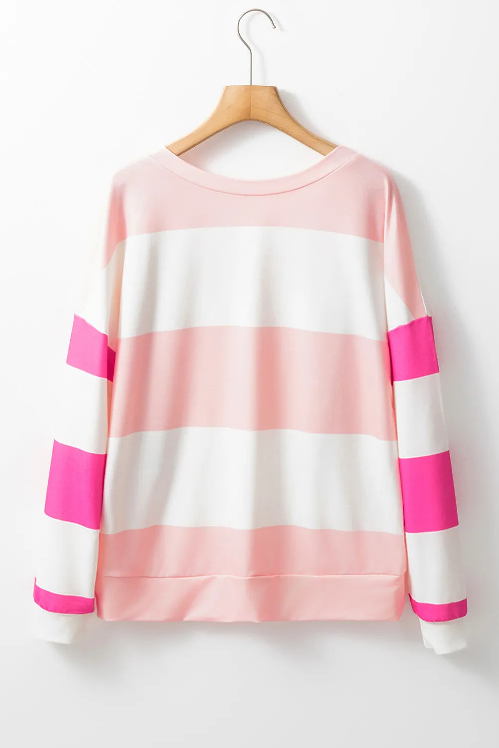 Striped sweatshirt in blush pink and white with hot pink block sleeves and crewneck.