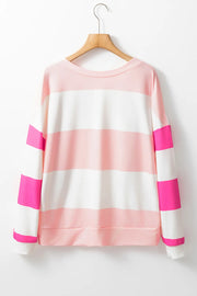 Striped sweatshirt in blush pink and white with hot pink block sleeves and crewneck.