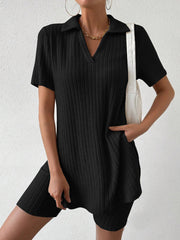 Black ribbed polo shirt and shorts set with a V-neck and collar, styled with a white bag.