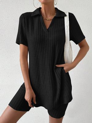 Black ribbed polo shirt and shorts set with a V-neck and collar, styled with a white bag.