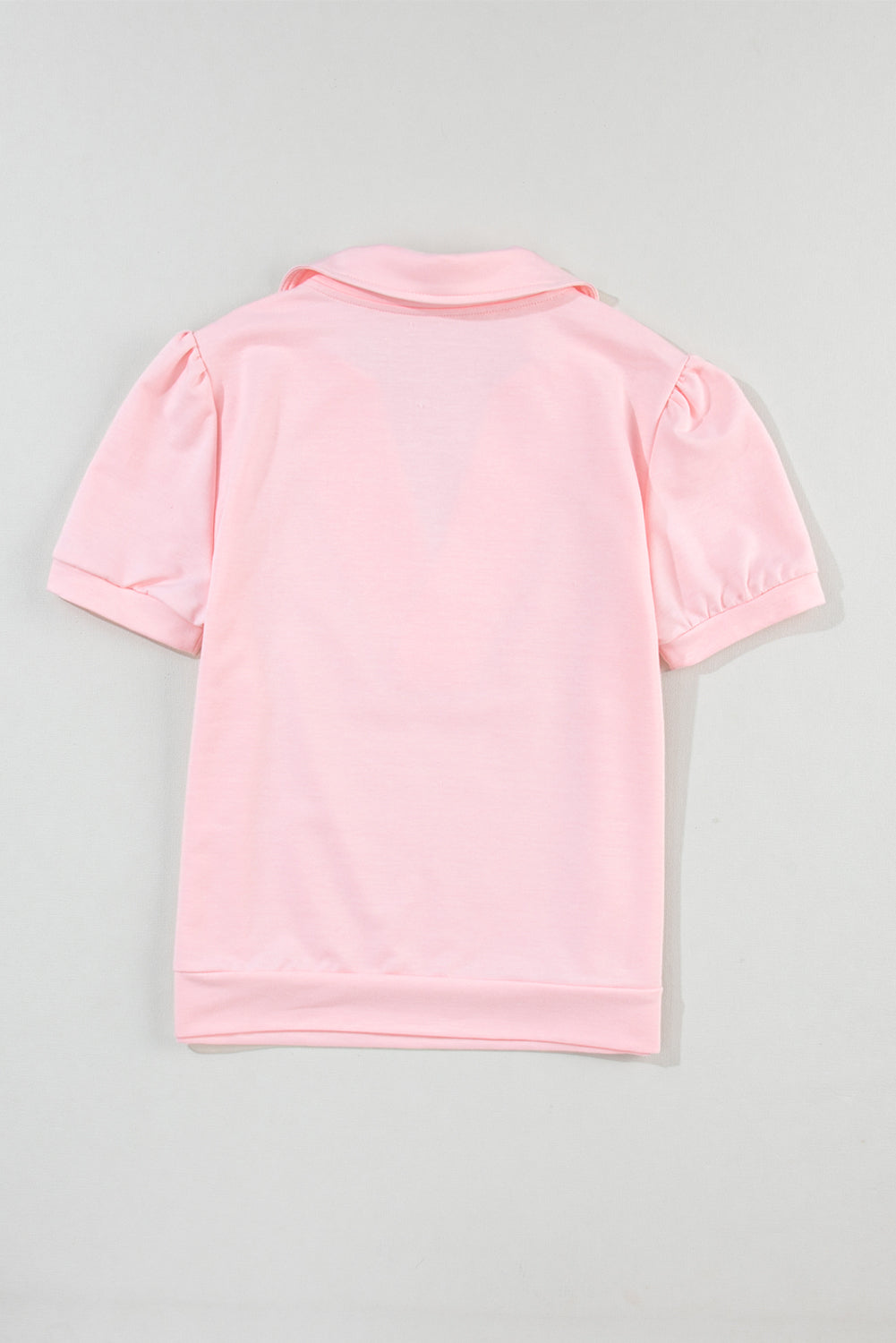 Blush pink V-neck collar tee with short puff sleeves and a casual fit.