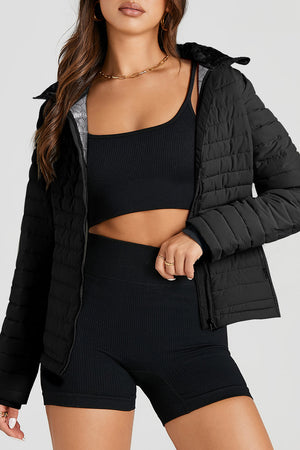 Black quilted stand collar puffer jacket with a faux fur trim and zip front.