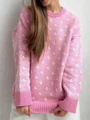 Blush pink knit sweater with allover white sailboat pattern and ribbed cuffs and hem.
