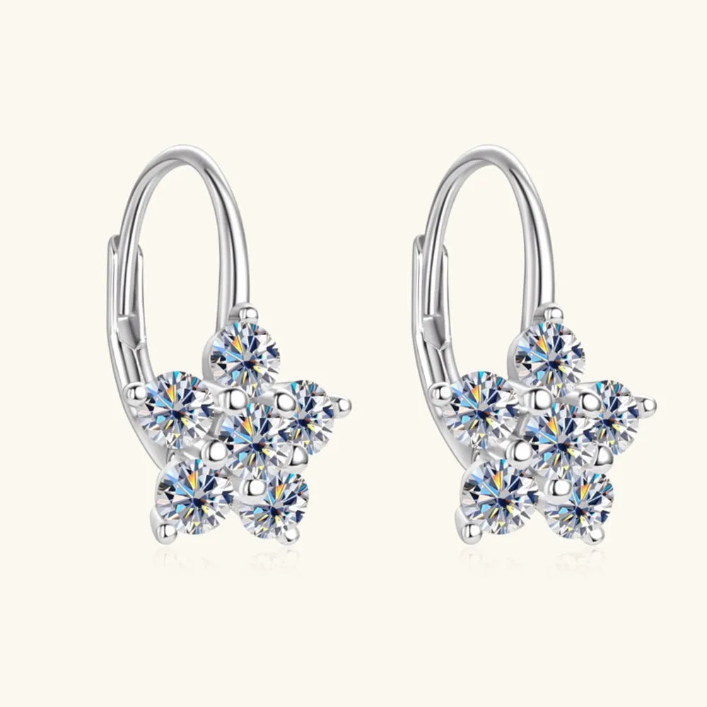 Silver huggie hoop earrings with a celestial star cluster design of clear cubic zirconia stones.