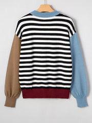Colorblock striped knit sweater with crew neck, black and white stripes, brown and blue sleeves, and maroon hem.