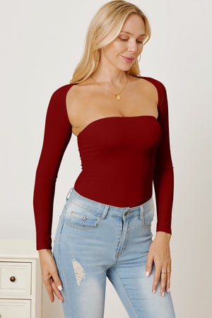 Burgundy bodysuit with long sleeves and a square neckline, styled with jeans.