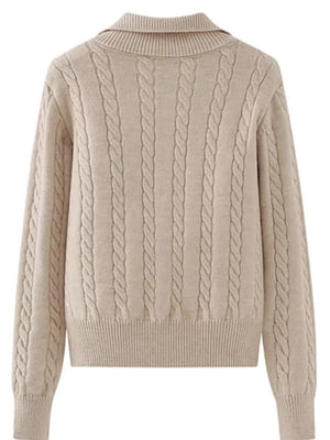 Beige cable knit quarter-zip pullover sweater with a ribbed collar and cuffs.