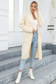 Ivory longline knit cardigan with fringe trim and pockets, open front, long sleeves