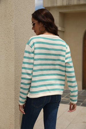 Crewneck cardigan with bold green and white stripes, long sleeves, and a relaxed fit.