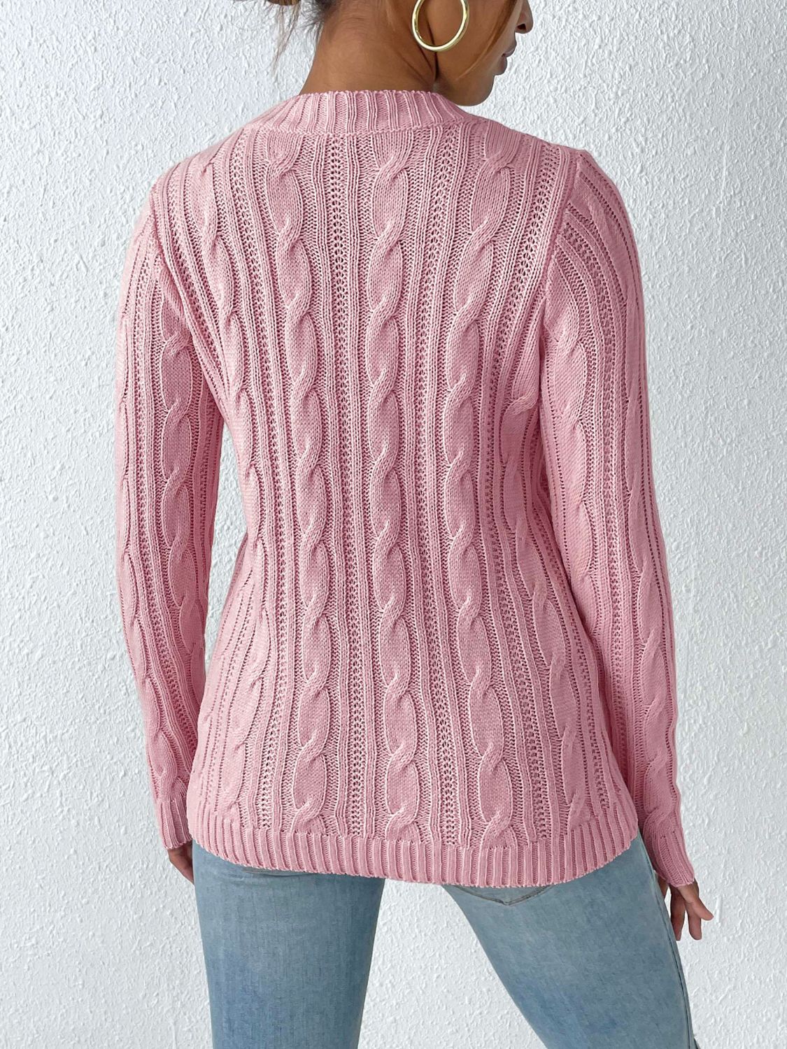 Dusty pink cable knit sweater with pearl embellishments, long sleeves, and crew neck.