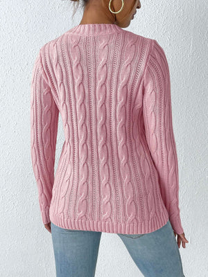 Dusty pink cable knit sweater with pearl embellishments, long sleeves, and crew neck.