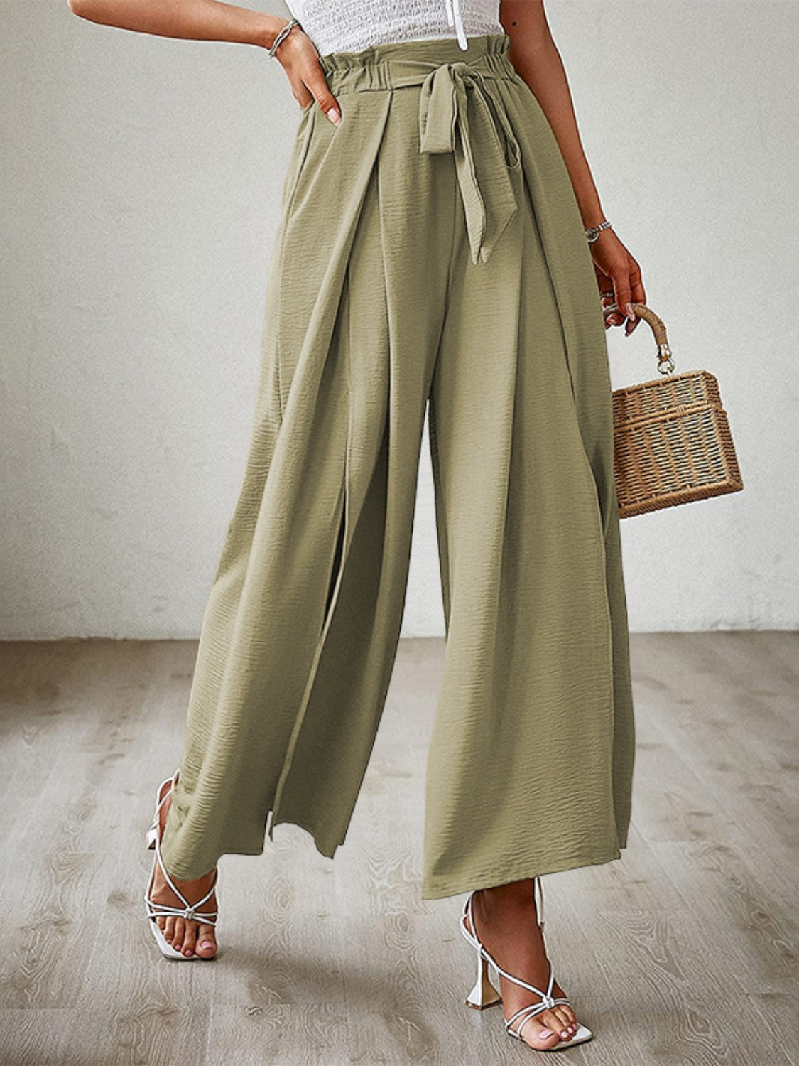 Paperbag waist palazzo pants in Matcha Green with side slits and a tie belt.