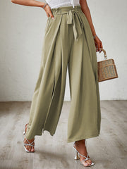 Paperbag waist palazzo pants in Matcha Green with side slits and a tie belt.