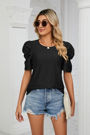 Black perforated sleeve volume top with textured fabric and round neckline.
