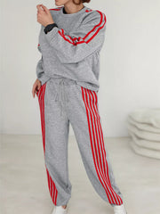 Grey loungewear set with red stripes on sleeves and pant legs.