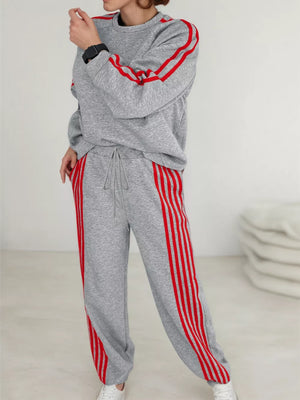 Grey loungewear set with red stripes on sleeves and pant legs.