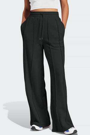 Black seamed wide leg lounge trousers with drawstring waist and pockets.