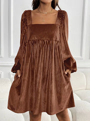 Brown velvet mini dress with square neckline, long sleeves, and pockets.