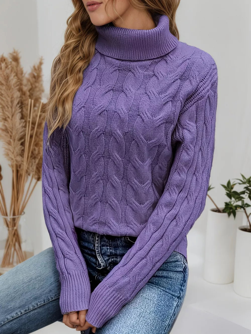 Purple cable-knit turtleneck sweater with ribbed cuffs and neckline.