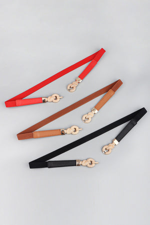 Linked knot elasticated waist belts in red, caramel, and black with gold alloy buckle detail.