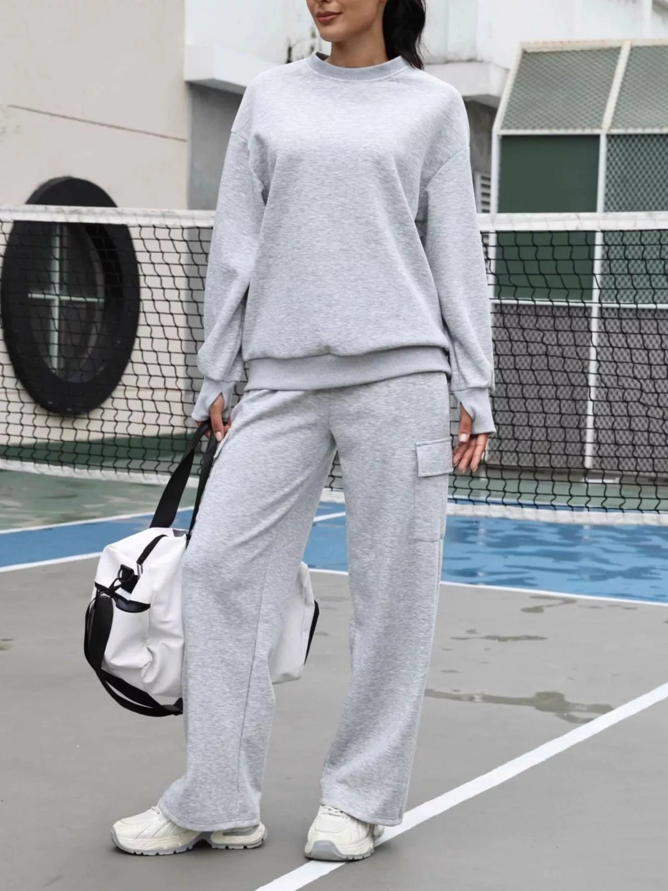 Light gray dropped shoulder sweatshirt and cargo pants loungewear set.