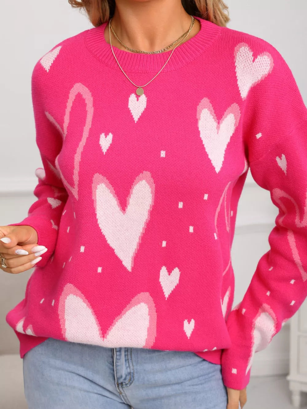 Heartfelt Fuchsia Knit Sweater with allover white hearts pattern, crew neck, and long sleeves.