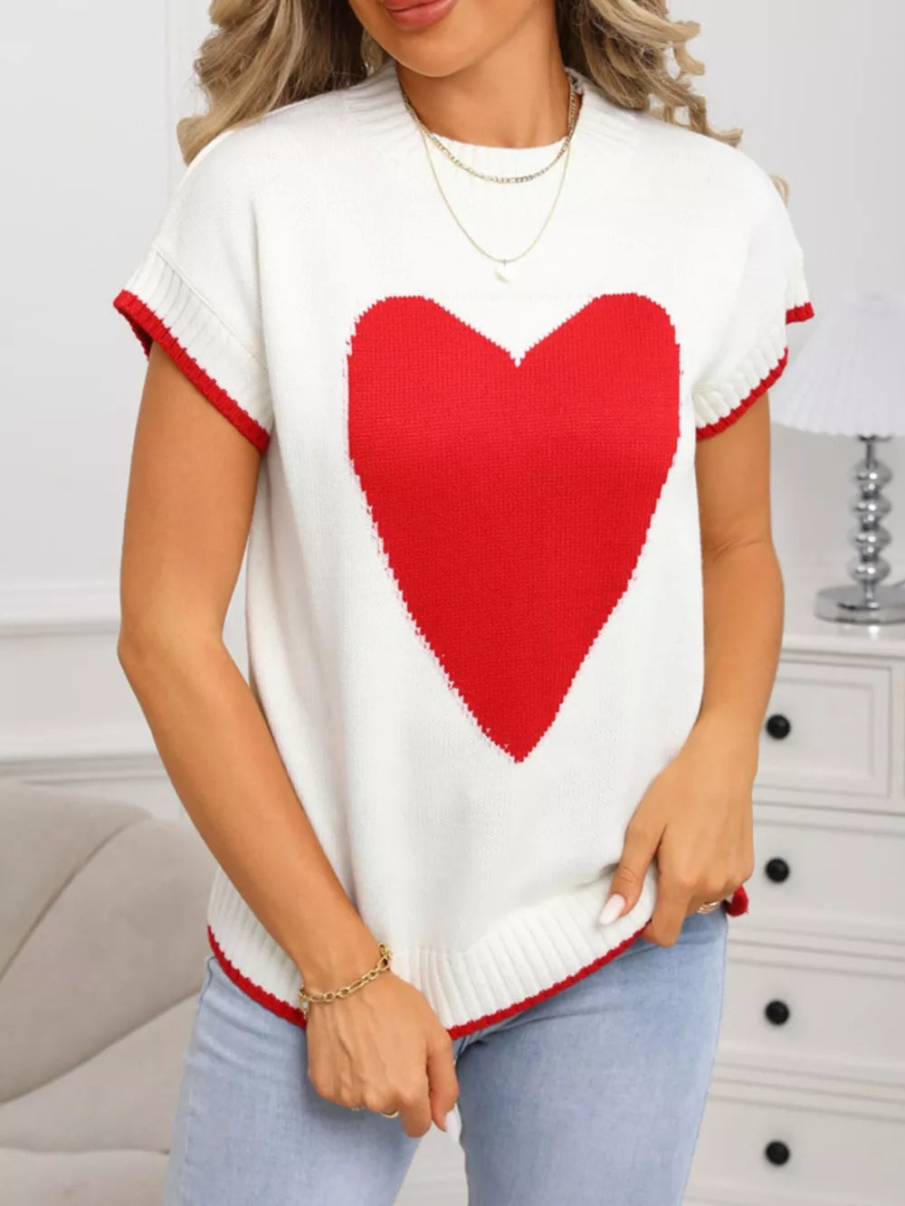 White knit top with large red heart, crew neck, ribbed accents and red trim