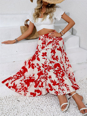 Crimson floral tiered midi skirt with a ruffled hem, styled with a white crop top.
