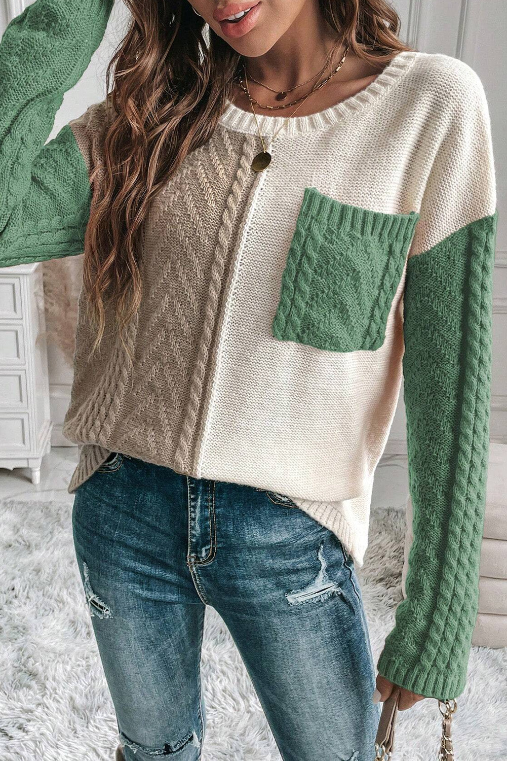 Colorblock cable knit sweater with green sleeves and pocket, crew neck, acrylic blend.