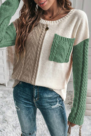 Colorblock cable knit sweater with green sleeves and pocket, crew neck, acrylic blend.