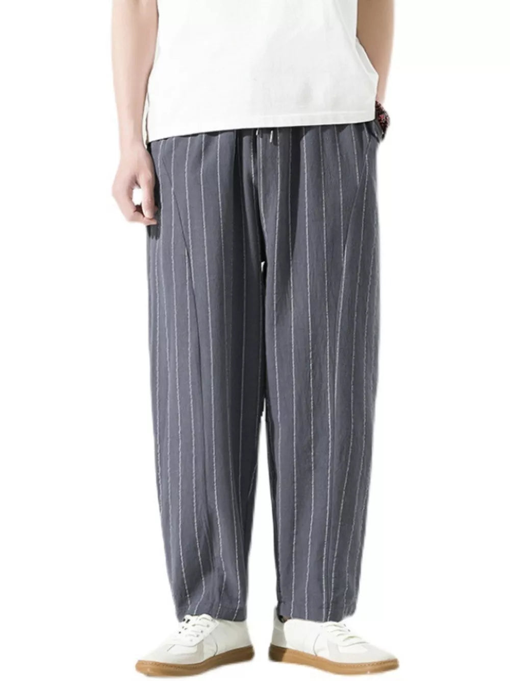 Men's grey relaxed fit sweatpants with white pinstripes and a drawstring waist.