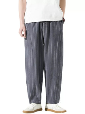 Men's grey relaxed fit sweatpants with white pinstripes and a drawstring waist.