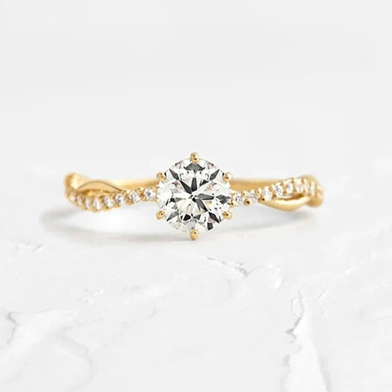 Gold twisted pavé zircon engagement ring with a round center stone.