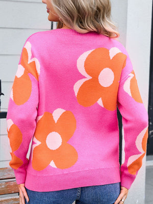 Oversized knit sweater in fuchsia pink with large orange floral print and crew neck.