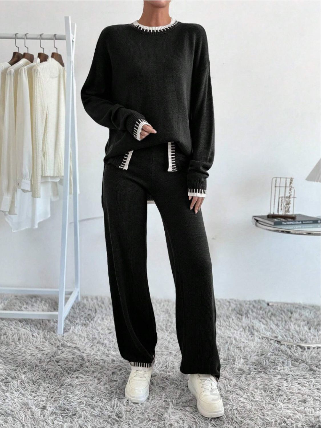 Black knit loungewear set with white trim detail on neckline, cuffs, and leg hem.