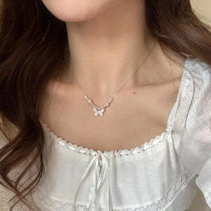 Charming butterfly and pearl necklace with delicate silver chain.