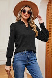 Black buttoned blouse with collared neckline and lantern sleeves