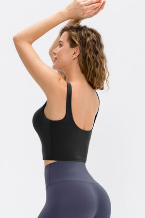 Black performance scoop crop top with wide straps and a cropped fit.