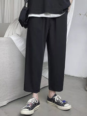 Black relaxed fit cropped sweatpants with drawstring waist and wide leg.