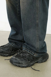 Dark wash wide-leg cargo jeans with visible stitching detail.