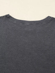 Dark gray waffle knit oversized sweatshirt with crew neck detail.
