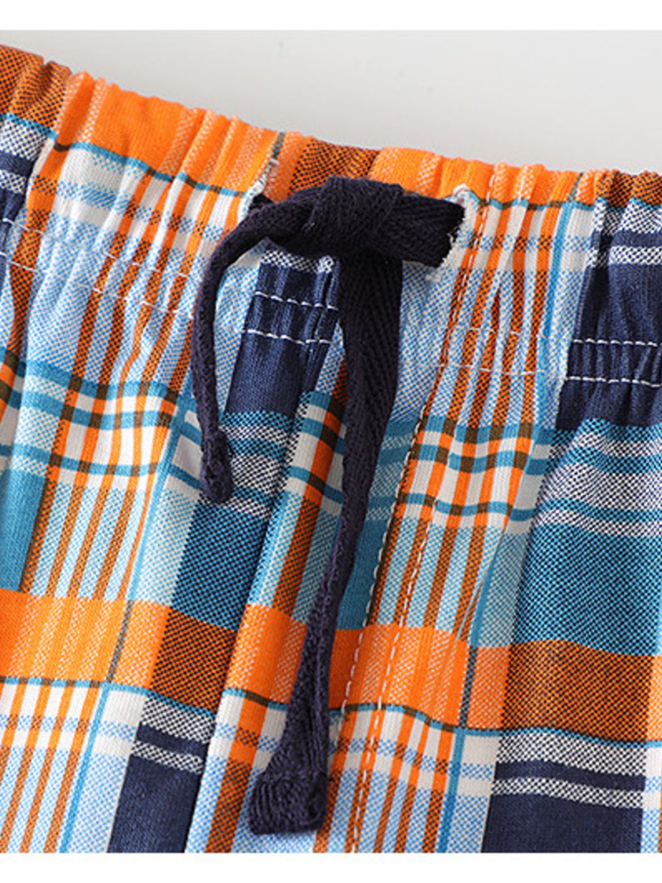 Toddler plaid shorts with elastic waist and drawstring in blue, orange, and white cotton.