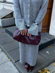 Grey ribbed knit cardigan with bell sleeves and matching midi skirt ensemble.