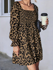 Leopard print mini dress with smocked bodice, square neck, and ruffled cuffs in olive brown.